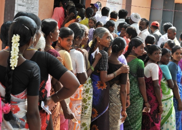 Women wait to vote outside an election polling booth in Nagendra Mangalam, some 135 km east of Bangalore, on May 13, 2009. (Dibyangshu Sarkar/AFP/Getty Images)