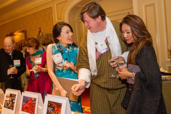 Asia Society volunteer Nan Chow chats with Alan Seem and Sonia Soo during the silent auction. (Drew Altizer/Asia Society)