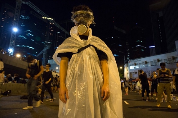A pro-democracy protestor stands before a photographer in Hong Kong as thousands of others remain on the streets of the city after a weekend of protests. (Paula Bronstein/Getty Images)