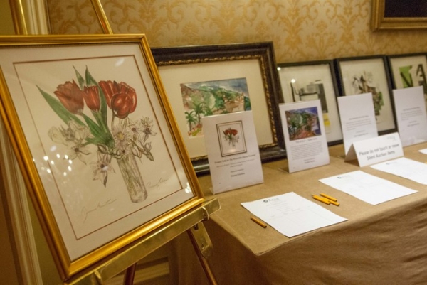 Silent auction items on display. In the foreground, a painting by Senator Dianne Feinstein. (Drew Altizer/Asia Society)