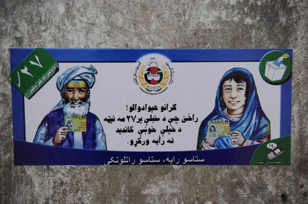 A poster urging Afghans to vote in upcoming elections is stuck to a wall in Kandahar province's Arghandab Valley on August 11, 2010. (Yuri Cortez/AFP/Getty Images) 