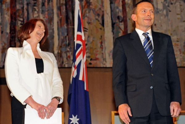 Australian Prime Minister Julia Gillard (L) laughs beside Federal opposition leader Tony Abbott (R) after she finally secured enough independents to form the new government at Parliament House in Canberra on September 7, 2010. (Torsten Blackwood/AFP/Getty Images) 