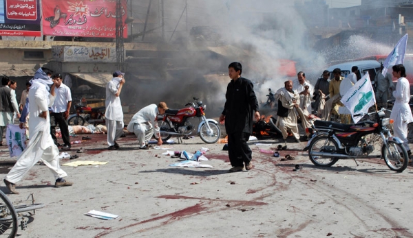 Pakistani Shiite Muslim men help injured blast victims at the site of a suicide bomb attack in Quetta on September 3, 2010. (Banaras Khan/AFP/Getty Images) 
