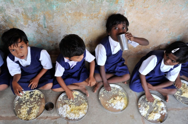 Indian schoolchildren eat food served as part of The 'Midday Meal' scheme at a Government Primary School in Hyderabad on June 23, 2010. (Noah Seelam/AFP/Getty Images) 