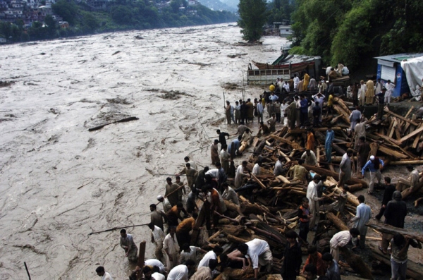 Residents stand by flood waters that entered a residential area of Muzaffarabad on July 30, 2010. Pakistan&apos;s northwestern Khyber Pakhtunkhwa and Punjab provinces are the hardest hit by the disaster. (Sajjad Qayyum/AFP/Getty Images)