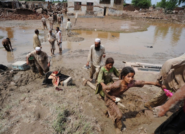 Flood victims on the outskirts of Peshawar evacuate their homes  on August 2, 2010. (STRDEL/AFP/Getty Images)