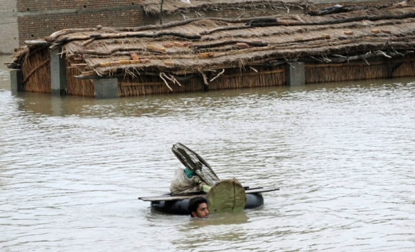 A resident shifts his belongings from a submerged home in Toree Band, 85 kilometers from Sukkur on August 6, 2010. (Asif Hassan/AFP/Getty Images)
