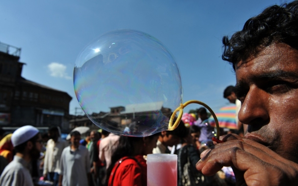 A Kashmiri vendor blows bubbles to attract customers ahead of the Eid-ul-Fitr festival at a market in Srinagar on September 9, 2010. (Sajjad Hussain/AFP/Getty Images)