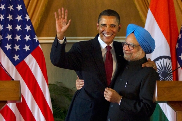 President Obama (L) waves as he is embraced by Prime Minister Singh (R) after speaking during a joint press conference at Hyderabad House on November 8, 2010 in New Delhi, India. The President will soon embark to Indonesia for his second stop for a 10-day tour of Asia. (Daniel Berehulak/Getty Images)