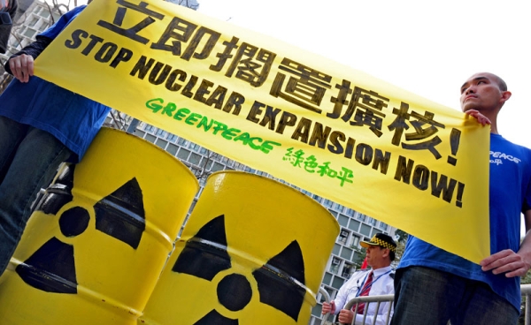 Members of environmental action group Greenpeace hold up an anti-nuclear banner in front of the Central Government offices in Hong Kong on March 22, 2011. (RICHARD A. BROOKS/AFP/Getty Images)