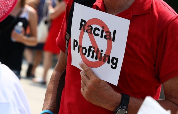 A man holds a sign against racial profiling during a protest with community and faith leaders from Arizona in front of the White House on July 7, 2010 in Washington, DC. (Mark Wilson/Getty Images)
