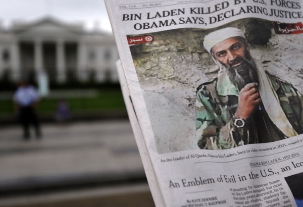 A man takes pictures of the front page of a newspaper featuring a picture of Al-Qaeda leader Osama bin Laden, in front of the White House in Washington, DC, on May 2, 2011. (Jewel Samad/AFP/Getty Images)