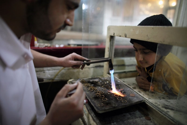A man melts gold to be re-formed as jewelry in a shop in Herat, Afghanistan, on Feb. 27, 2010. Undeveloped gold and other mineral deposits in Afghanistan have the potential to transform its economy. (Majid Saeedi/Getty Images) 