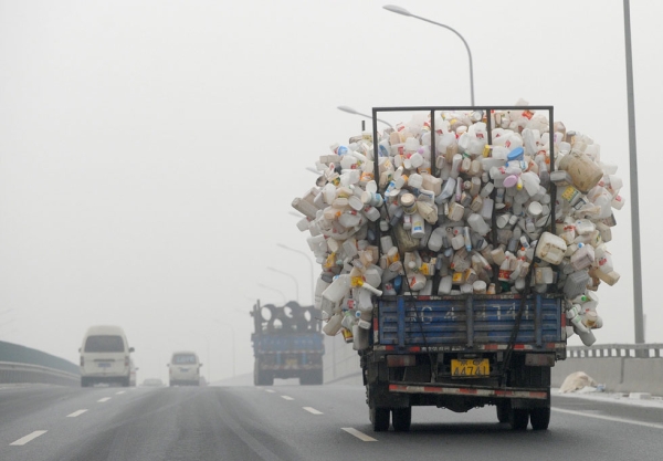 A truck containing used plastic bottles travels along a highway covered in haze in Beijing on December 5, 2011. (Liu Jin/AFP/Getty Images)