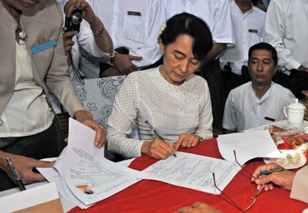 Aung San Suu Kyi (C) registers to run as a candidate in upcoming by-elections at the Thanlyin township election commission office on the outskirts of Yangon on Jan. 18, 2012. (Soe Than Win/AFP/Getty Images) 