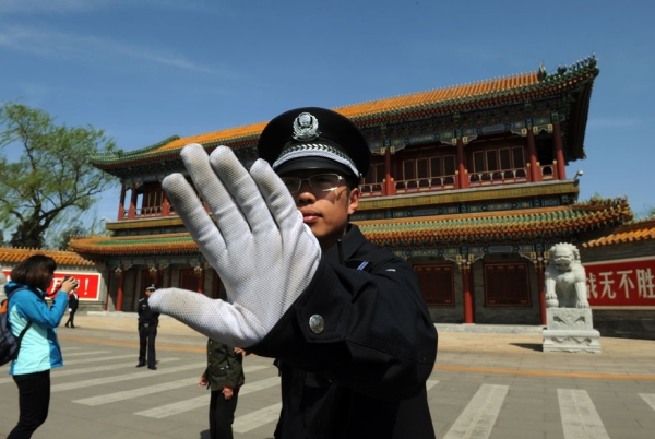 A Chinese policeman blocks photos from being taken outside Zhongnanhai, central headquarters for China's Communist Party, after the sacking of politician Bo Xilai from the country's powerful Politburo, in Beijing on April 11, 2012. (Mark Ralston/AFP/Getty Images)