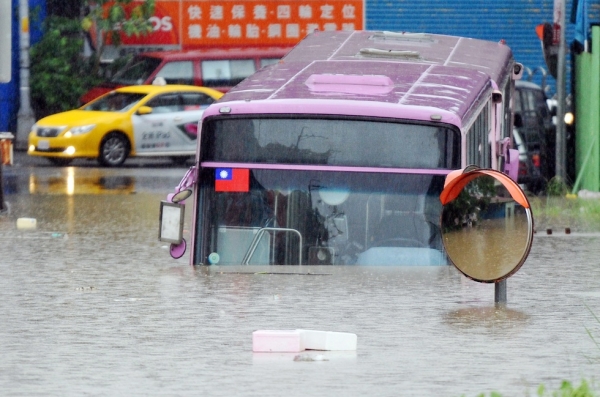A bus sits half submerged on a flooded road in New Taipei City on August 2, 2012.  (Mandy Cheng/AFP/GettyImages) 