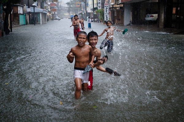 Young boys still keep smiling after the typhoon Soala in Manila, Philippines on August 9, 2012. (Matt Paish 2011/Flickr)