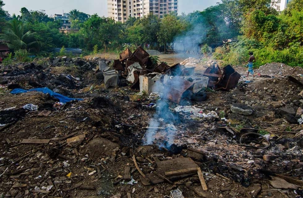 An illegal trash site behind a college. (Jonathan Raa)
