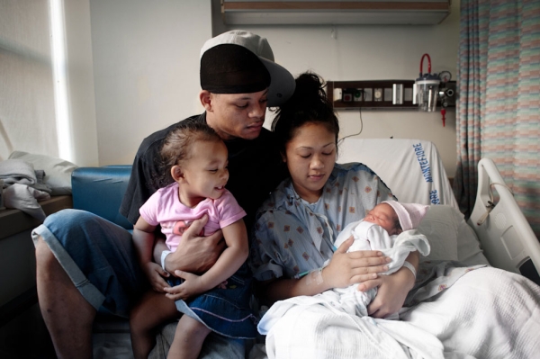 Joseph, 30, Sothea, 28, and Sovahnny, 2, at Montefiore Hospital in The Bronx, N.Y., after the delivery of their newest child. (Pete Pin)
