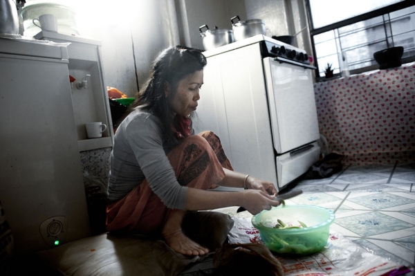 Thon Khoun, 47, cooks in the kitchen of her Bronx apartment. Mrs. Khoun immigrated as a refugee in 1985 and is a single mother of four. (Pete Pin)