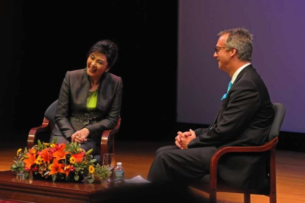 Yingluck Shinawatra onstage with Ambassador Eric G. John, who headed the United States' embassy in Thailand from 2007 to 2010. (Elsa Ruiz)