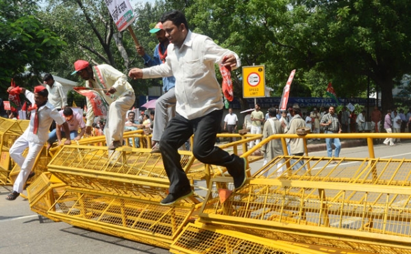 Supporters from India's opposition parties jump police barricades during a nationwide strike in New Delhi on September 20, 2012. (Raveendran/AFP/Getty Images)