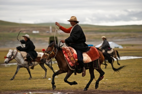 Nomad cowboys from far and wide gallop to the edge of the fairgrounds. (Michael Yamashita)