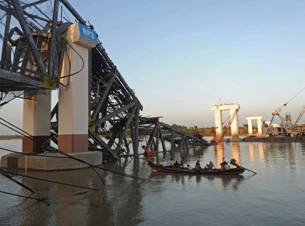 A rescue boat works near a damaged bridge in Kyauk Myaung township in central Myanmar following a 6.8-magnitude quake on Nov. 11, 2012. (Soe Than Win/AFP/Getty Images)