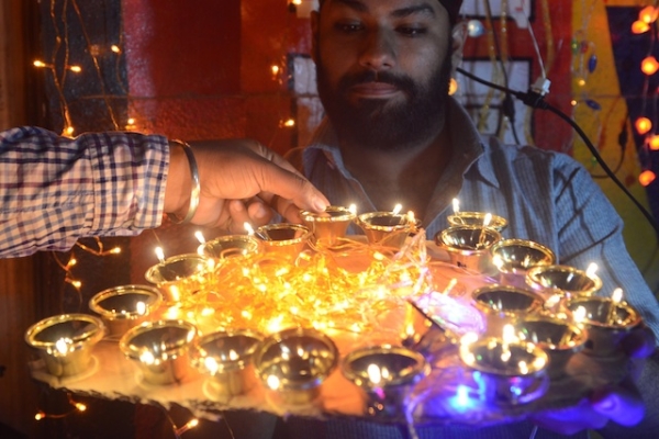 A man holds up decorative oil lamps at a shop ahead of Diwali, the Hindu festival of lights, in Amritsar, India on November 6, 2012. (NARINDER NANU/AFP/Getty Images)