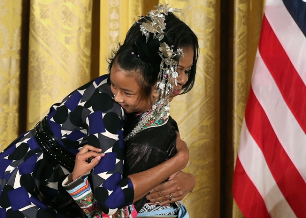 First Lady Michelle Obama hugs Lianyun Wu during an awards ceremony for the President's Committee on the Arts and the Humanities in the East Room at the White House in Washington, D.C. on November 19, 2012. (Mark Wilson/Getty Images)