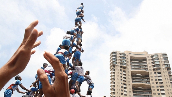 A team of men in India balance and reach toward the sky in the documentary "The Human Tower." (Goldcrest Films International)