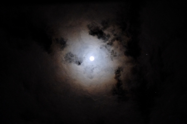 The moon shines bright on a cloudy night in Tokyo, Japan on November 29, 2012. (takuhitosotome/Flickr)