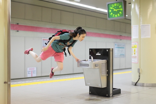 Natsumi Hayashi levitates in front of a public drinking fountain in her image "May 6, 2011." (Natsumi Hayashi)