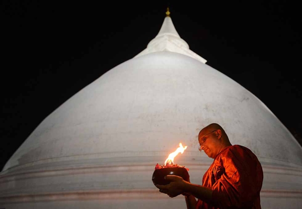 A Sri Lankan Buddhist monk offers special prayers at the Kelaniya Temple in Kelaniya, Sri Lanka, on December 31, 2012. (Ishara S.Kodikara/AFP/Getty Images)