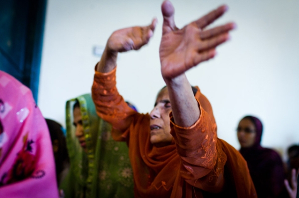 An elderly woman singing along with a Christmas carol at Dhala United Methodist Church, Lahore, Pakistan in December 2011. (Nushmia Khan)