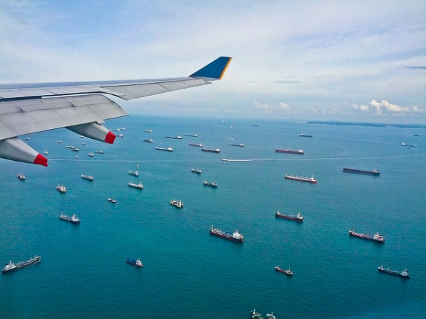 Ships can be seen gliding on the water from an airplane window flying over the Strait of Malacca on January 21, 2013. (leogaggl/Flickr)