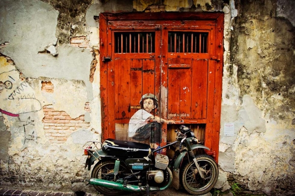 Ernest Zacharevic leaving his mark with vibrant street art in George Town, Penang. "Boy on a Bike" is a mural on Ah Quee Street. (Catherine Mar)