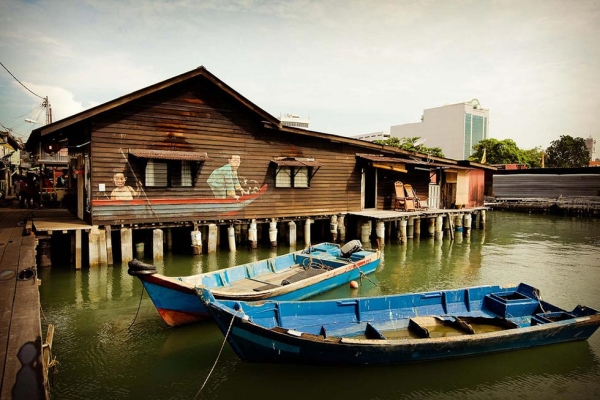 "Children on Boat," a mural painted on a stilt-house in the Chew Jetty, shows two children playing in a local boat by the shore. (Catherine Mar)