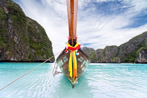A long tail boat sits anchored at Maya Beach, Thailand on February 20, 2013. (efkarmanine/Flickr)