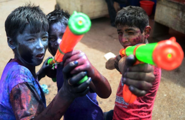 Young Pakistani Hindus pose with water guns during Holi celebrations in Karachi, Pakistan on March 26, 2013. (Rizwan Tabassum/AFP/Getty Images)