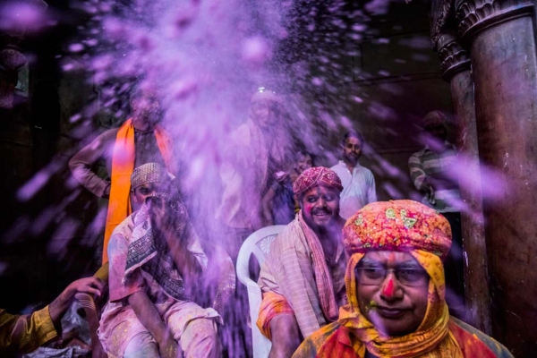 People celebrate Holi with purple powder at the Banke Bihari temple in Vrindavan, India on March 26, 2013. (Daniel Berehulak/Getty Images)