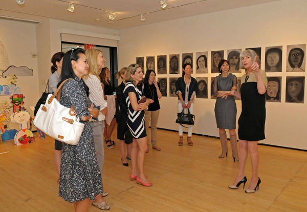 Head of Museum Education Programs Nancy Blume (R) leads a tour of the student exhibition. (Elsa Ruiz/Asia Society)