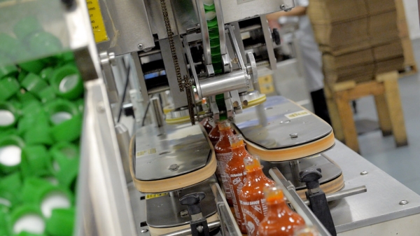 Production of Sriracha Hot Chili Sauce at Huy Fong Food’s Rosemead, CA building. The sauces are produced on machinery that has been specially modified by Tran, who taught himself machining and welding skills. (Griffin Hammond)
