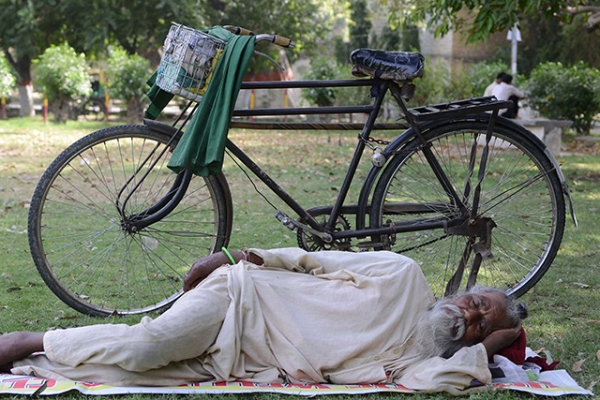 A man finds refuge in the shade during a heat wave in Amritsar, India on May 22, 2013. (Narinder Nanu/AFP/Getty Images)