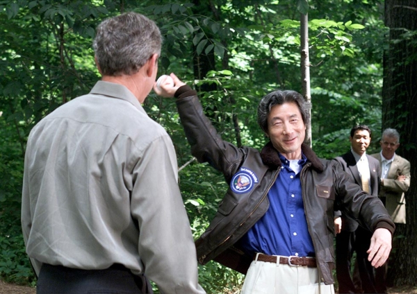 Japanese Prime Minister Junichiro Koizumi winds up to throw a baseball to U.S. President George W. Bush at Camp David, the presidential retreat in Maryland, USA on June 30, 2001. (Mark Wilson/Getty Images)