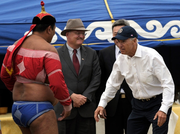On the same trip, Vice President Joe Biden faces off with a Mongolian wrestler during the mini-Naadam staged in his honor in Ullan Bator, Mongolia on August 22, 2011. (Goh Chai Hin/AFP/Getty Image