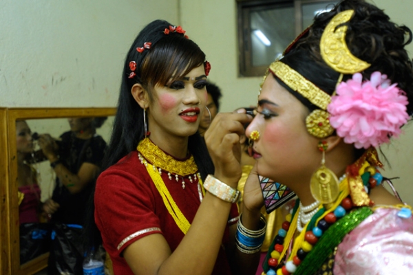 Transgendered performers in colorful ornaments carefully put on make-up backstage in Kathmandu, Nepal on May 17, 2013. (Prakash Mathema/AFP/Getty Images)