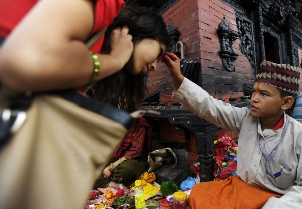 Further tika blessings for devotees at the Pashupatinath Temple in Kathmandu on July 22, 2013. (Prakash Mathema/AFP/Getty Images)