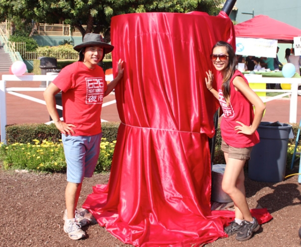 Albert Chu (L) and Patricia Huang (R) stand in front of Giant Boba Cup ahead of the unveiling ceremony at Santa Anita Park in Arcadia, California on August 3, 2013. (626 Night Market)